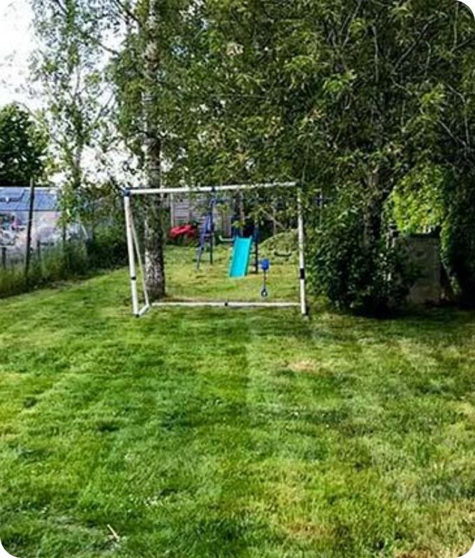a backyard with a nice and good looking lawn and a football door